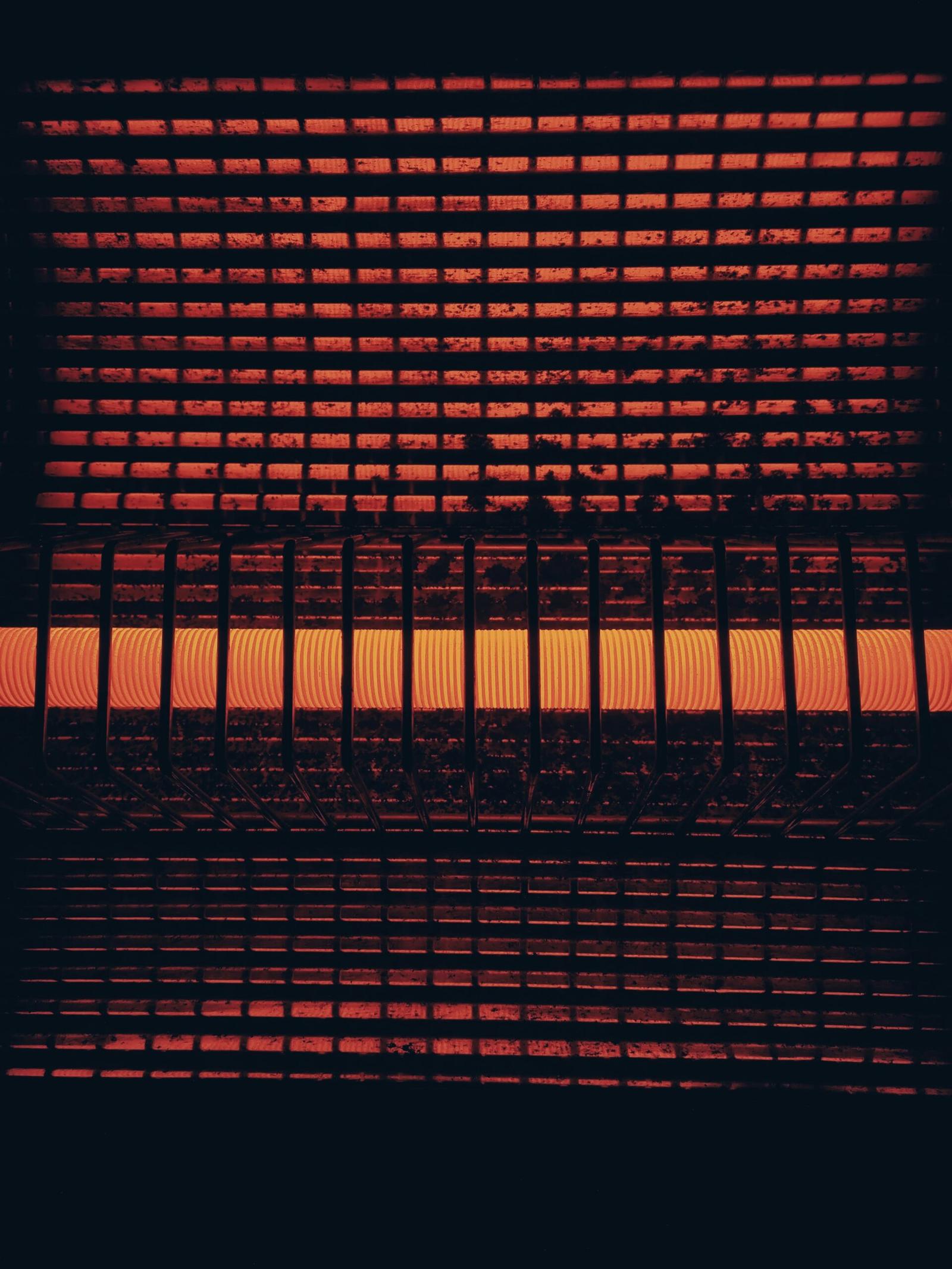 a close up of a heater that is red and orange; Choosing the Best Room Heater for Home: Comfort and Health Combined