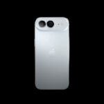 An ultra-thin iPhone Air 2 in titanium with dual 48MP camera lenses resting on a minimalist studio podium.
