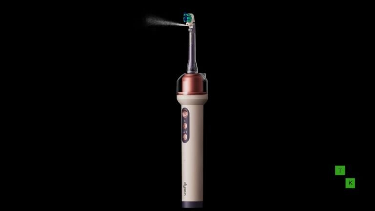The Dyson CameraJet AI toothbrush in Ceramic Ultra Blue resting in its sleek auto-refilling charging dock on a modern bathroom countertop.