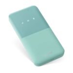 The compact Huawei Mobile WiFi 5 eSIM portable hotspot in cyan resting on a minimalist wooden travel desk.