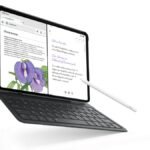 The Infinix Xpad 30 Pro tablet in Twilight Purple docked with its keyboard folio and X Pencil 20 stylus on a modern study desk.