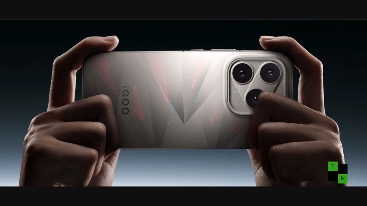 The iQOO 16 Legend Edition smartphone in white leather with BMW M Motorsport tricolor stripes resting beside its retail box and wireless charger.
