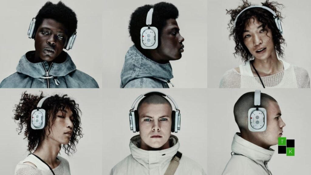 A pair of Nothing Headphone 1 Pro over-ear headphones with transparent earcups and aluminum headband resting on a dark slate surface.