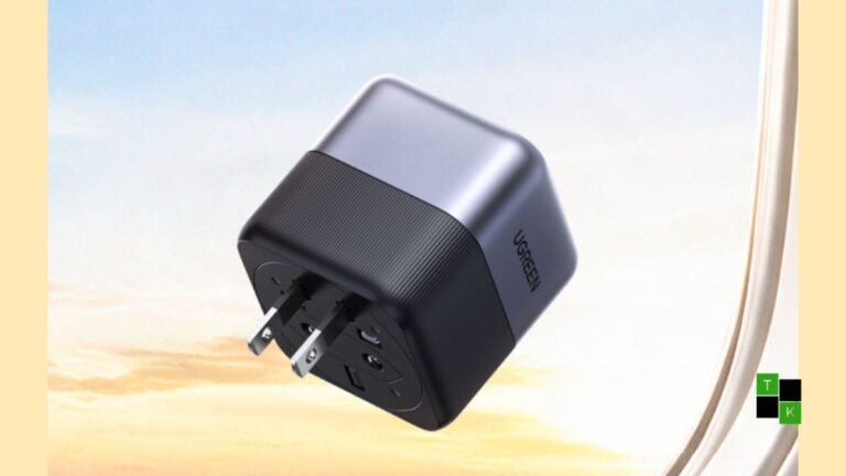 The Ugreen 65W GaN travel adapter showing its compact cubic metallic gray body and 360-degree rotating plug mechanism.