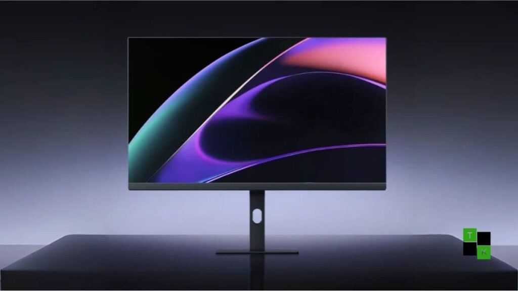 The Redmi Monitor A27U Type-C 120Hz 4K display on a modern desk showing an editing timeline and connected to a laptop via USB-C.