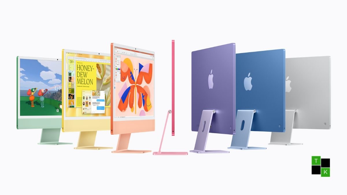 Apple 24-inch iMac with M6 in Blue finish resting on a light wood studio desk showing its 4.5K Retina display and color-matched keyboard.