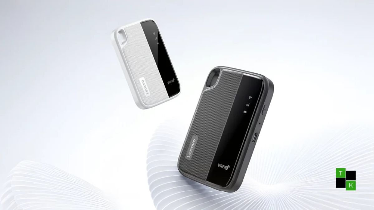 Lenovo Portable Wi-Fi 6+ model L016 pocket hotspot resting on a wooden travel table beside a laptop, displaying subtle LED status indicators.
