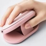 Logitech Pebble Up dual-form mouse in Tonal Rose finish shown in raised 35-degree ergonomic comfort mode next to a compact laptop.