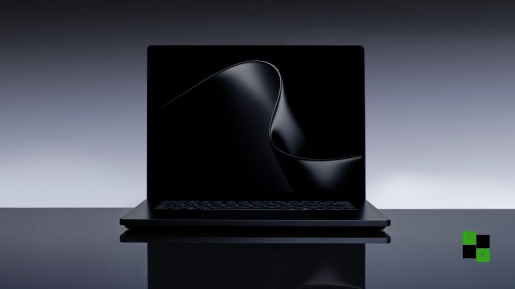 Microsoft Surface Laptop Ultra in Matte Obsidian open on a minimalist creator desk, displaying a vibrant 15-inch Mini-LED screen with local code models active.