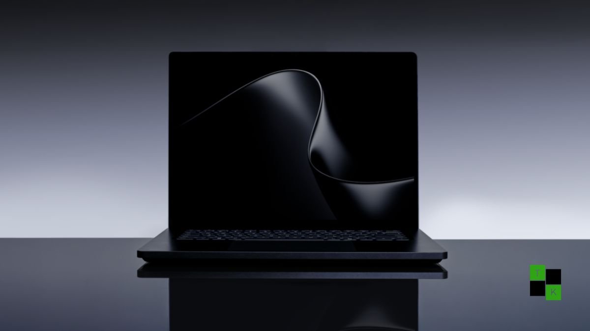 Microsoft Surface Laptop Ultra in Matte Obsidian open on a minimalist creator desk, displaying a vibrant 15-inch Mini-LED screen with local code models active.
