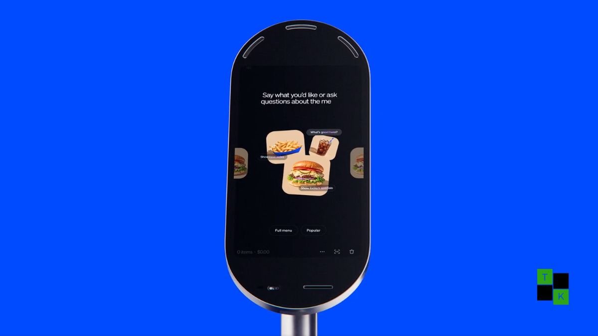 A modern standalone Square Kiosk featuring a 21.5-inch vertical touchscreen and integrated payment reader on a clean wooden restaurant counter.